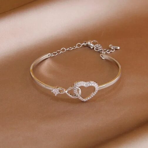 This fashion brand jewelry piece features a charming hollow heart design, adorned with sparkling crystals for a hint of glamour 6