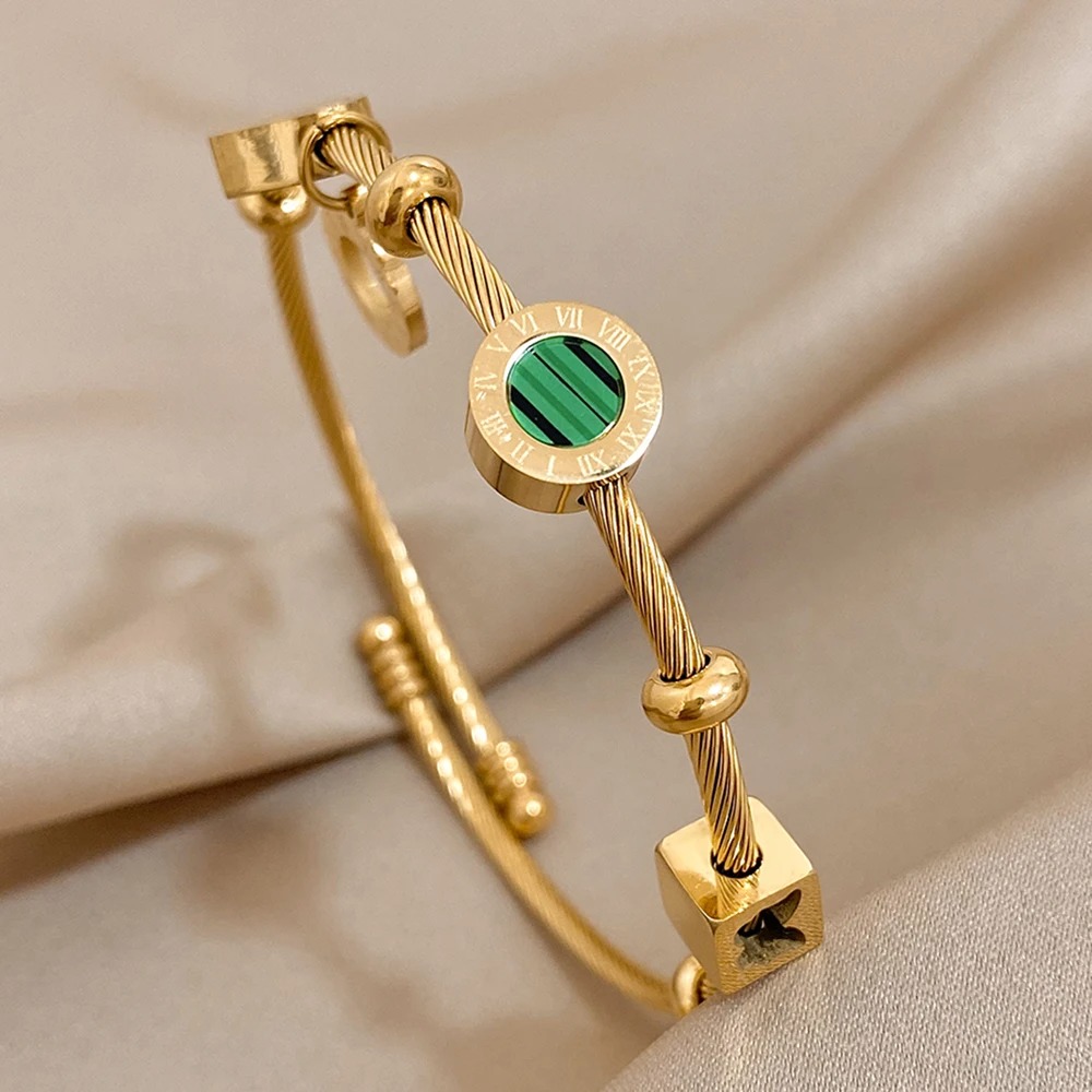 Elevate your style with our Women's Stainless Steel Malachite Roman Letters Charm Bangle Bracelet. This stunning piece features a luxurious gold color finish and exquisite malachite inlays, adding a touch of sophistication to any ensemble. Crafted from high-quality stainless steel, this bracelet is not only stylish but also durable and waterproof, perfect for daily wear. The elegant Roman letters design adds a timeless charm, making it a versatile accessory for any occasion. Whether you're dressing up for a special event or adding a chic touch to your everyday look, this bracelet is a perfect choice. Ideal as a thoughtful gift, it combines modern elegance with classic appeal. Shop now to enhance your jewelry collection with this exquisite piece. Crafted from high-quality stainless steel, this bracelet is not only stylish but also durable and waterproof, perfect for daily wear 1