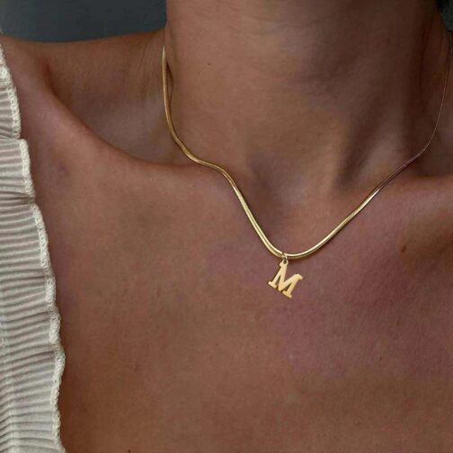 This exquisite piece features an initial letter pendant, beautifully crafted and gold-plated for a luxurious finish.