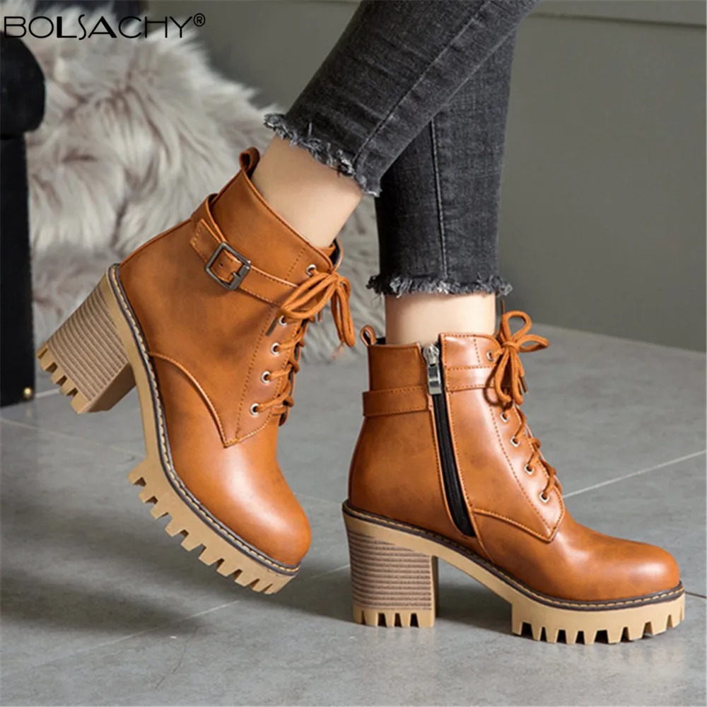 Crafted from high-quality artificial leather, these lace-up boots feature a stylish buckle detail that adds a modern, edgy touch. 1
